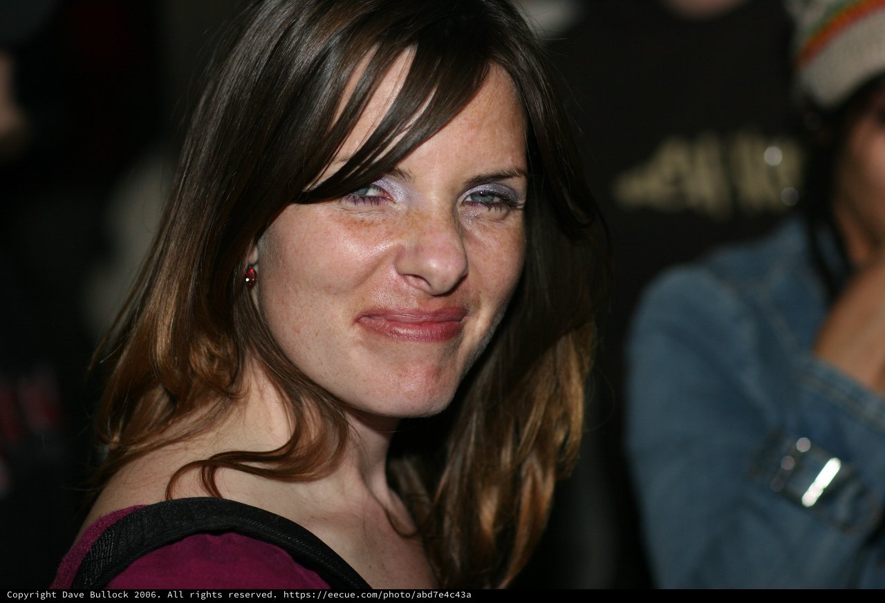 Woman Smiling Warmly at Evening Social Event