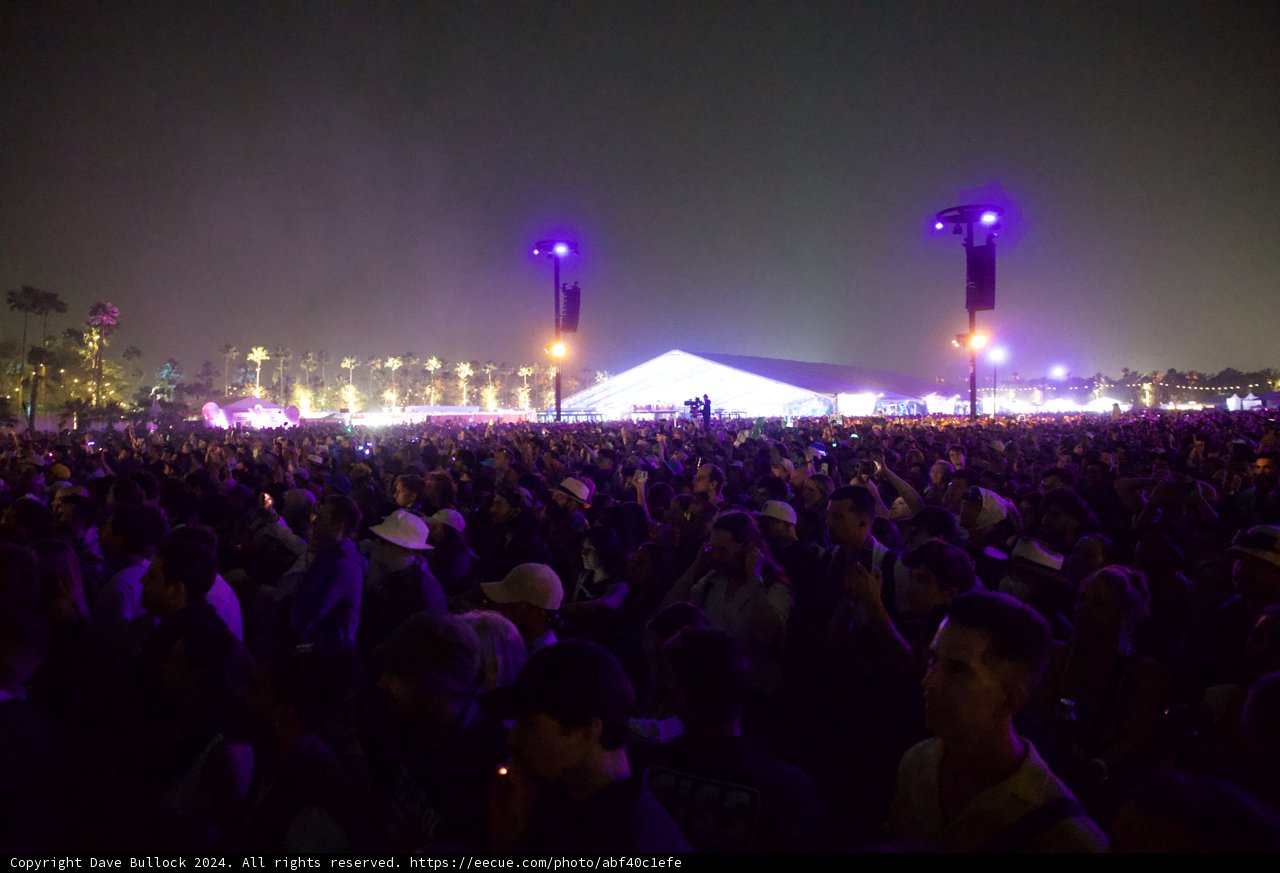 Euphoric Night at Coachella 2024: A Sea of Faces Under Purple Hues