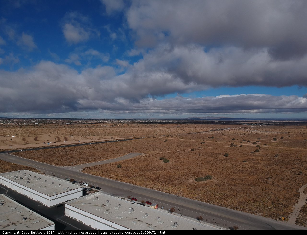 Desert Highway under Cumulus Clouds