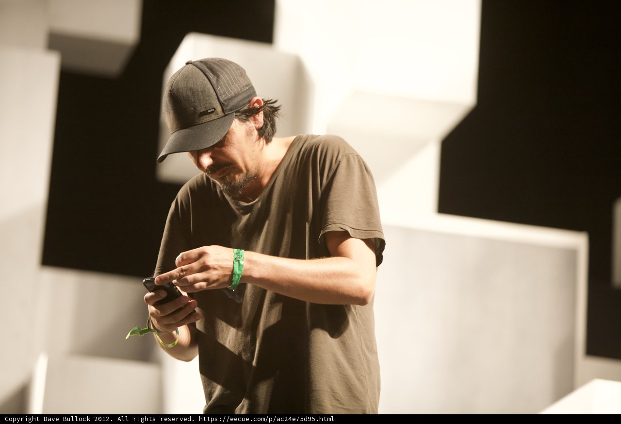 Amon Tobin checking his phone at Coachella