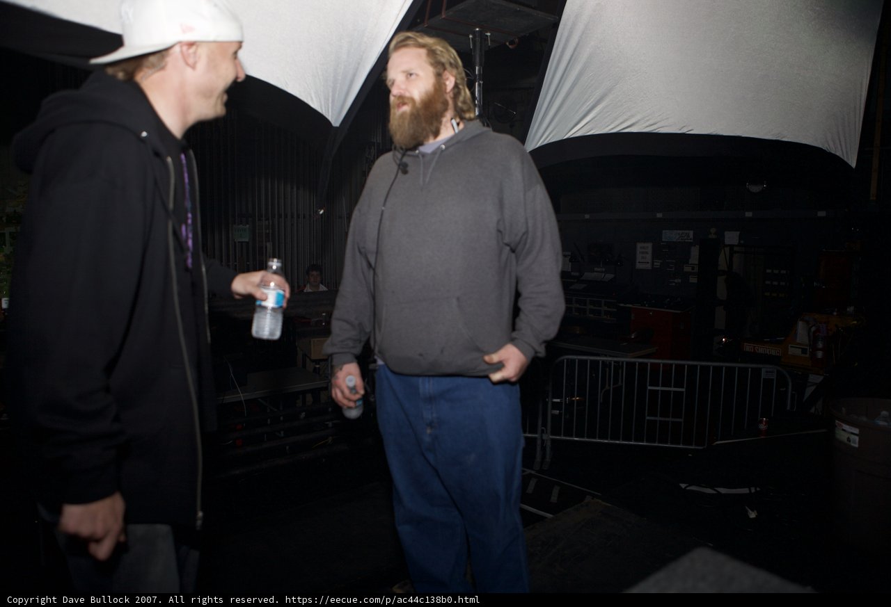 Two Men in Hats in a Dark Room