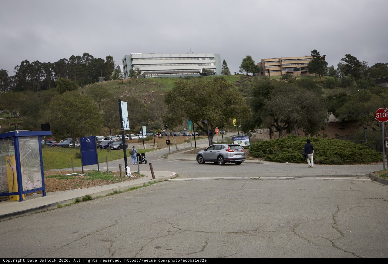 Modern University Campus on Hillside Under Overcast Sky