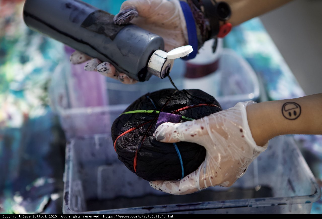 Gloved Hand Holding Black Ball
