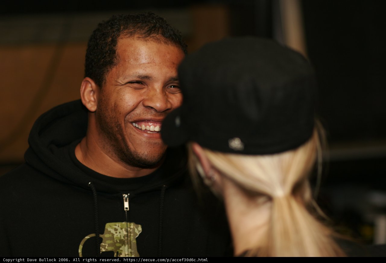 Smiling Man in Black Hoodie with Woman
