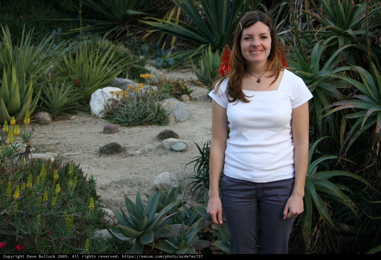 Smiling Woman Amid Desert Garden Succulents