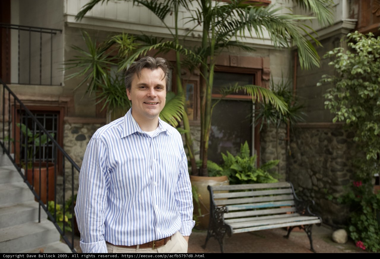 Striped Shirted Man in Front of House