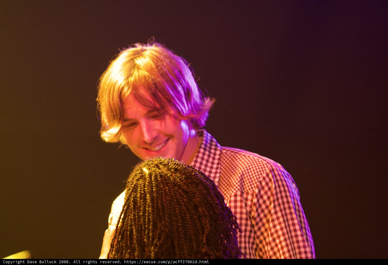 Smiling Performer with a Microphone