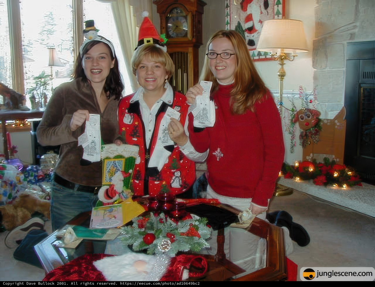 Three Women in Festive Christmas Sweaters Show Off Their Cards