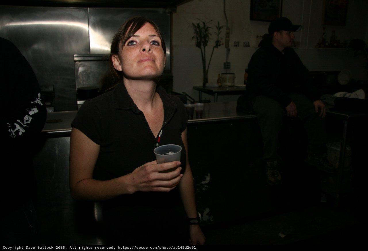 Woman Holding Drink Cup at Dimly Lit Venue