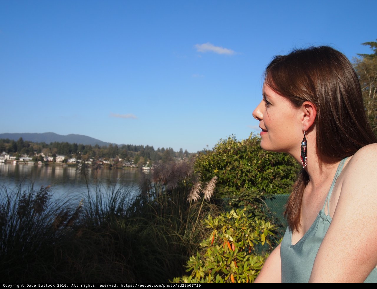 Woman Gazing Serenely Over a Tranquil Lakeside