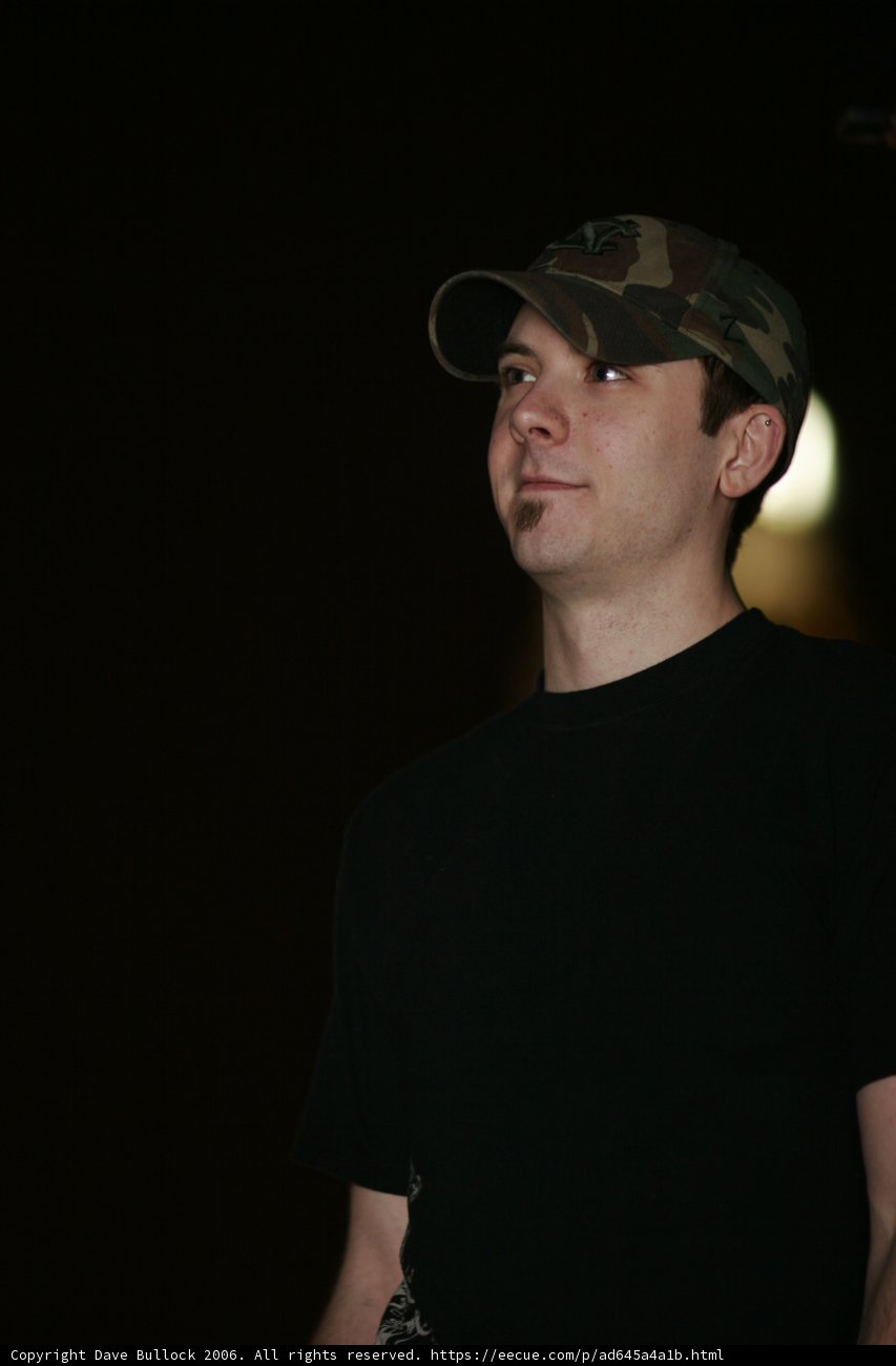 Black Shirted Man with Baseball Cap and Sunglasses