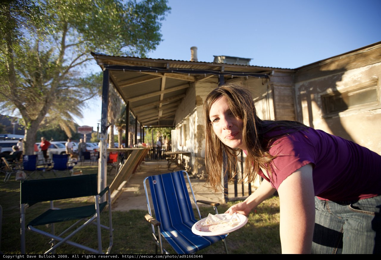 Young Woman at Outdoor Gathering in Desert Town