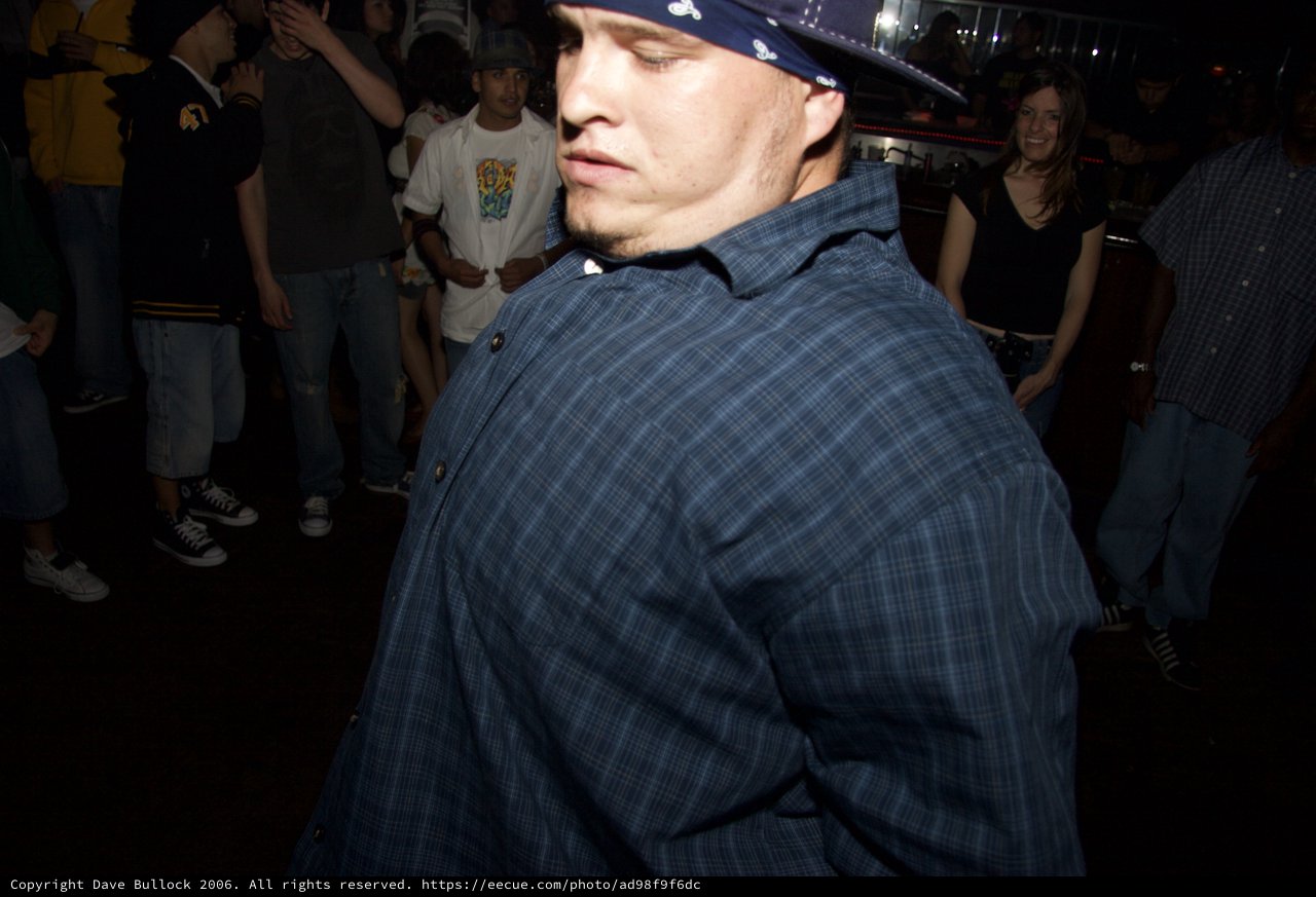 Young Man Dancing at Crowded Nightclub Party