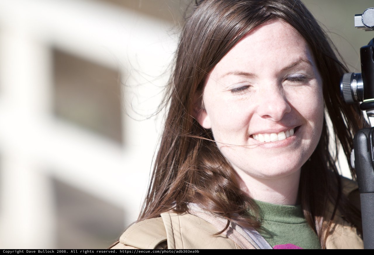 Smiling Woman in Bright Sunlight with Camera