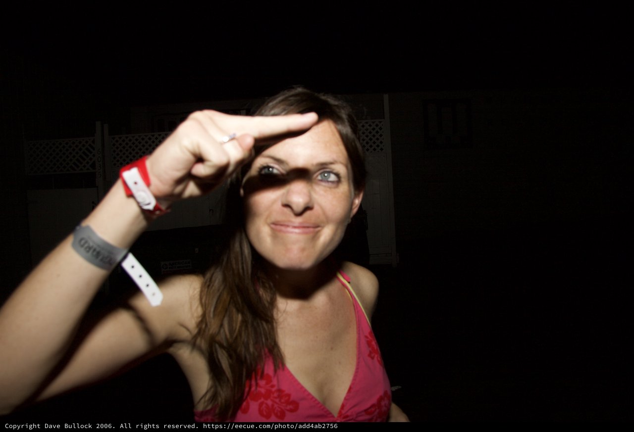 Woman Flashing Peace Sign at Late Night Event