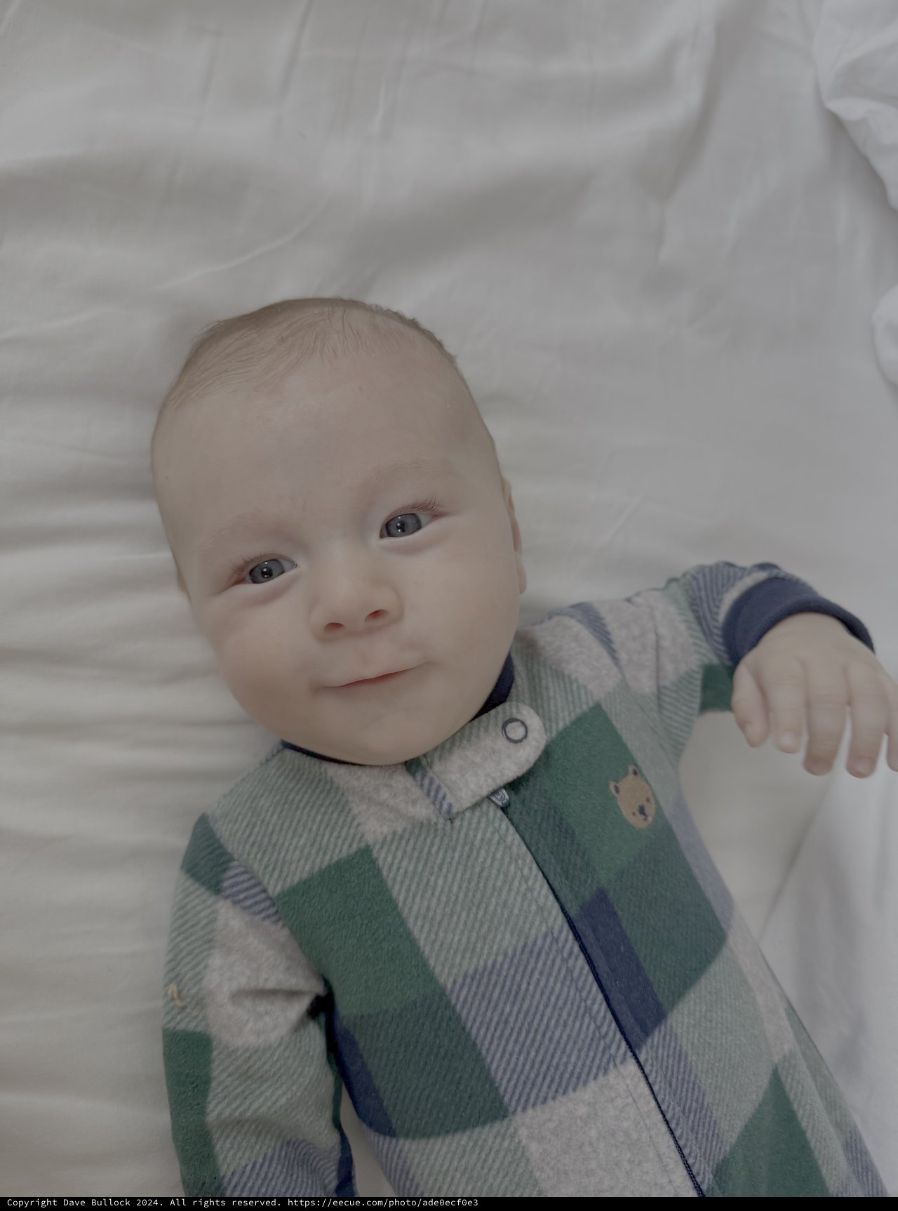 Sweet Baby in Striped Outfit on White Bedding