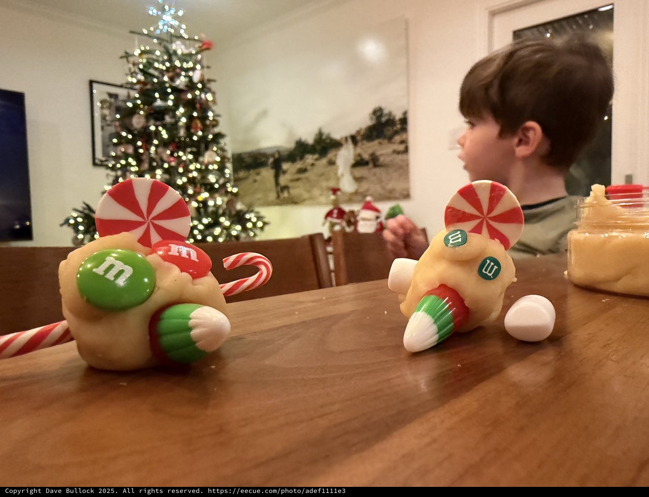 Child Decorating Christmas Candy Race Cars at Home