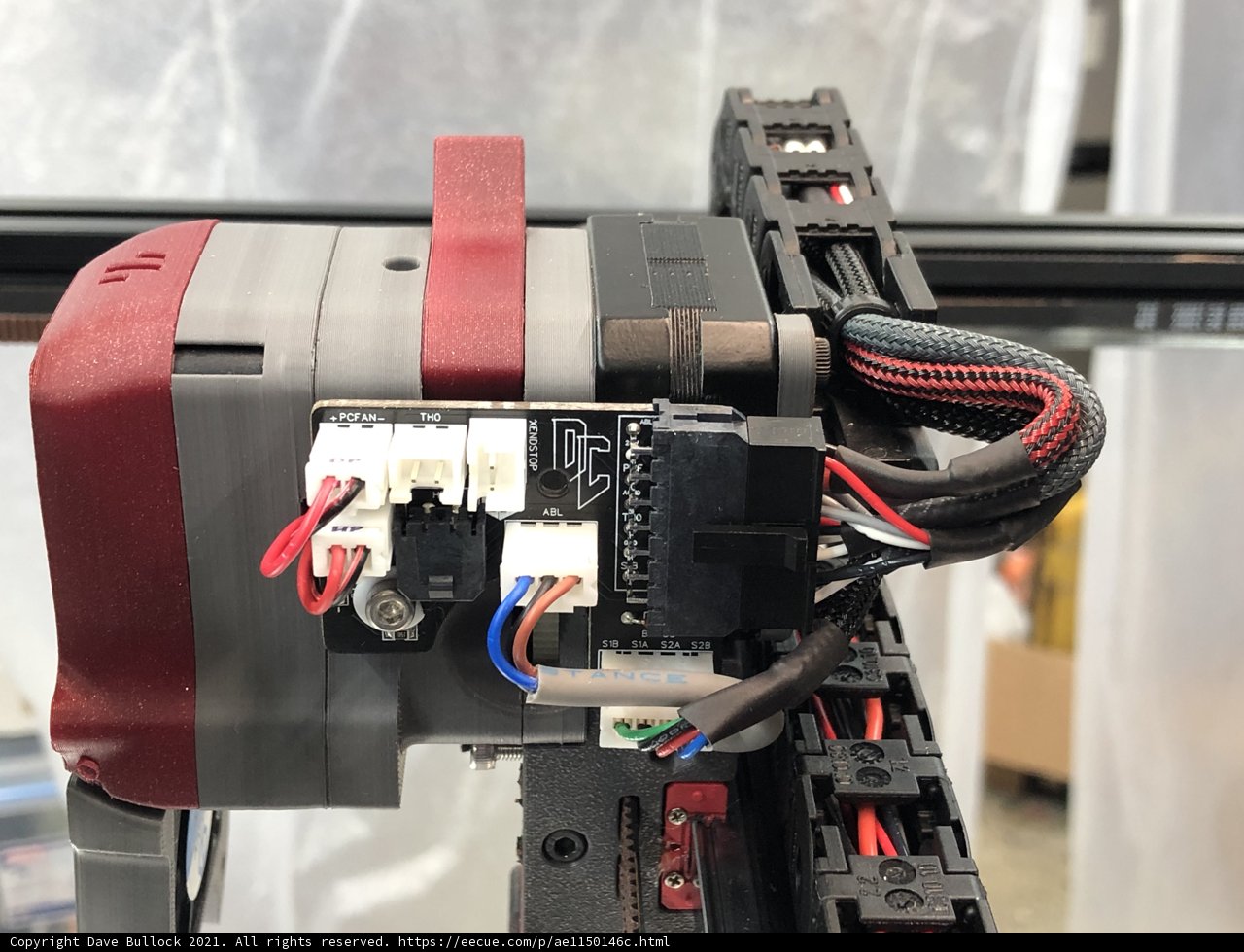 A Close Up of a Red and Black Machine with Wires Attached