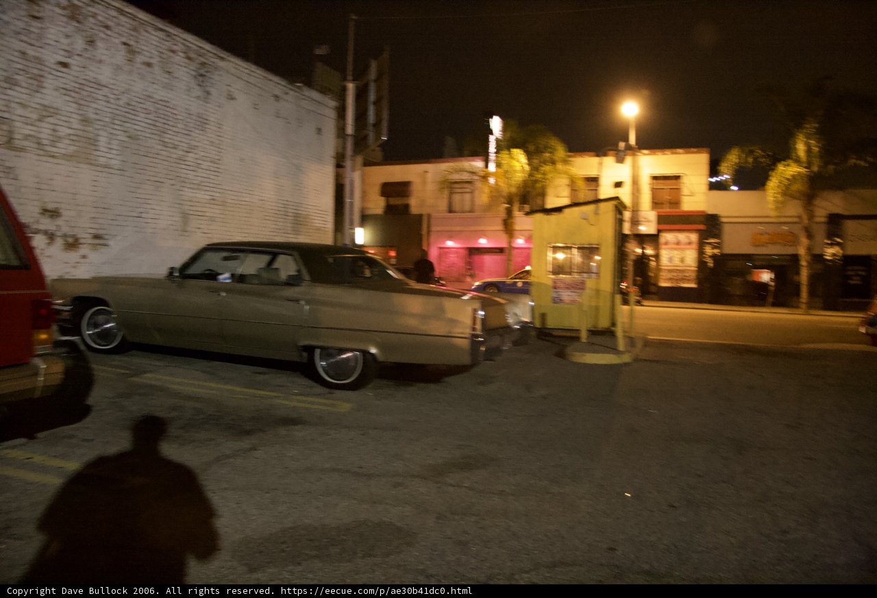 Nighttime Coupe Parked in Front of Building