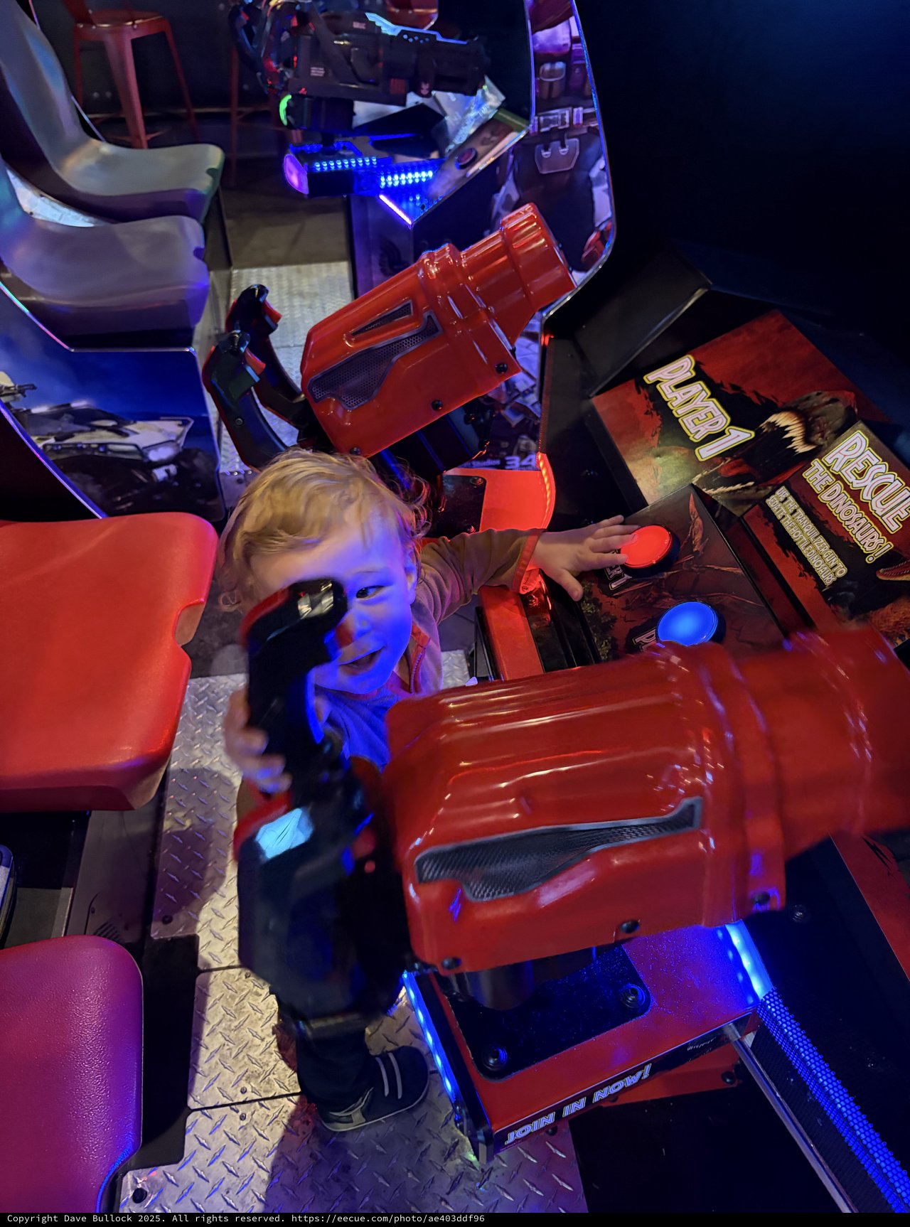 Young Child Playing Arcade Racing Game at Entertainment Venue