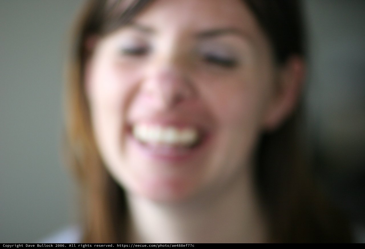 Joyful Close-Up Portrait of Smiling Young Woman
