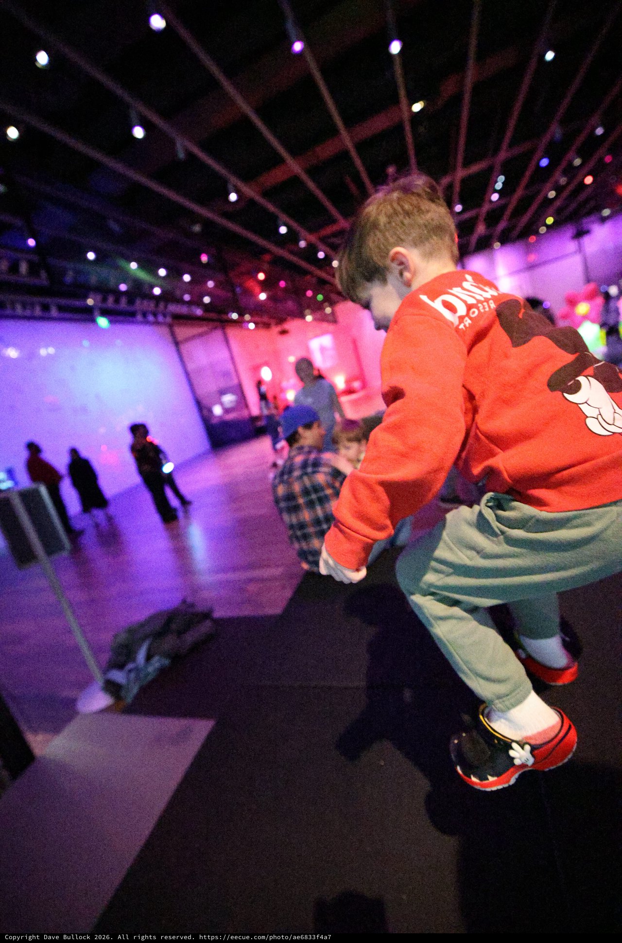 Child Dancing at Baby Rave Event Under Purple Lights