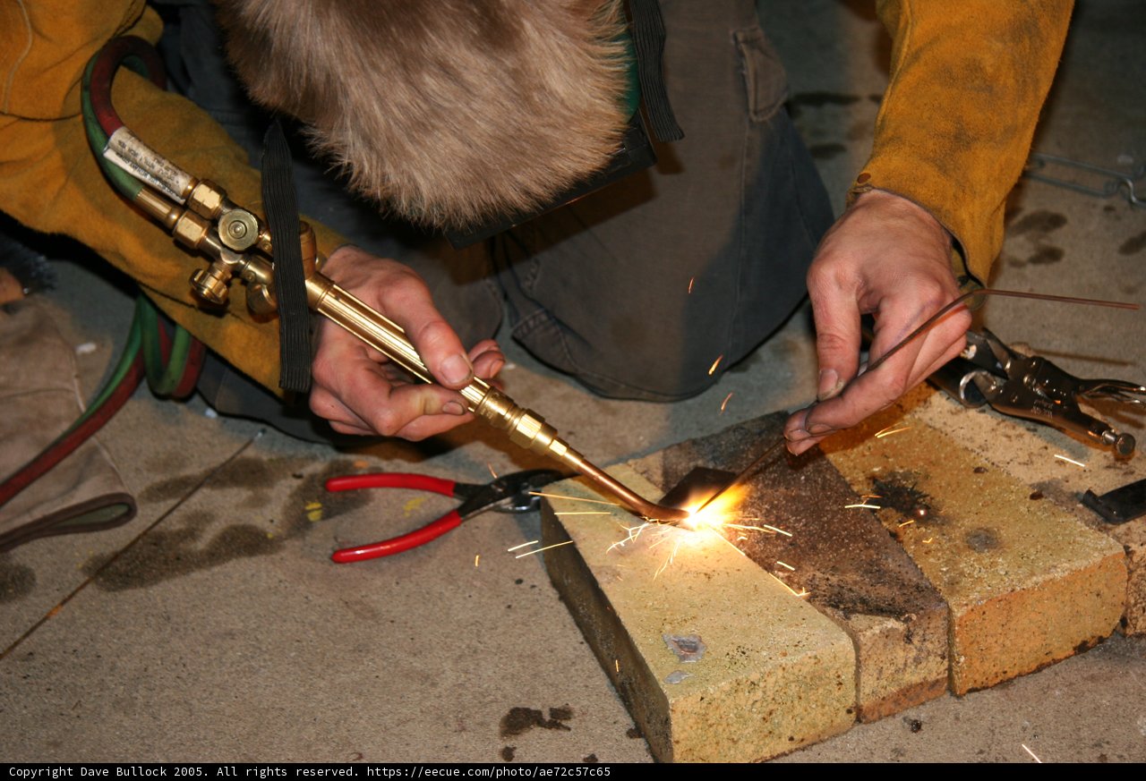 Sparks Fly as Man Welds Metal