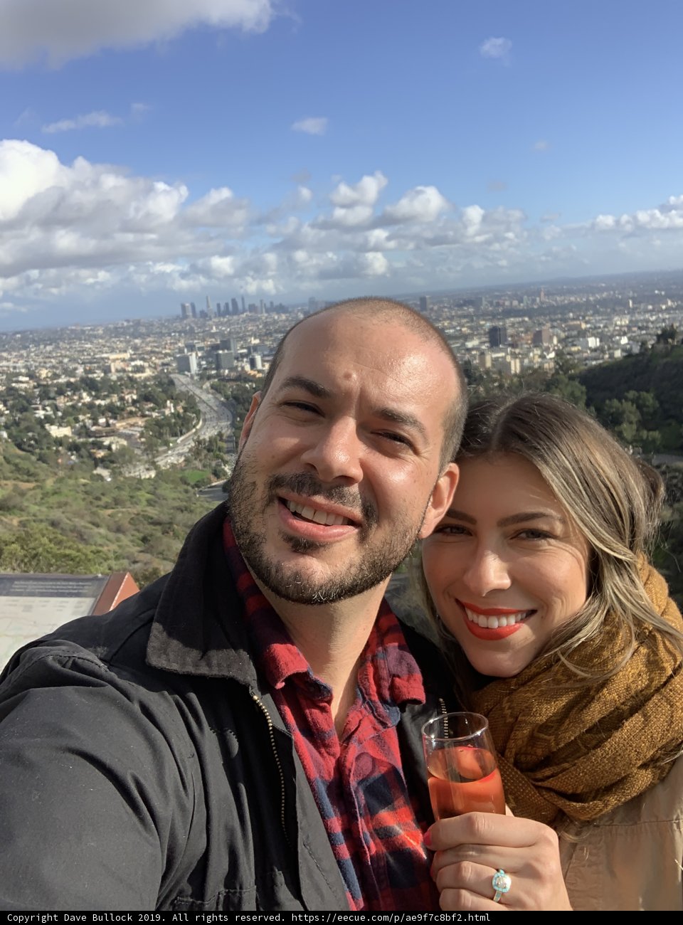 Happy couple captures city skyline in selfie