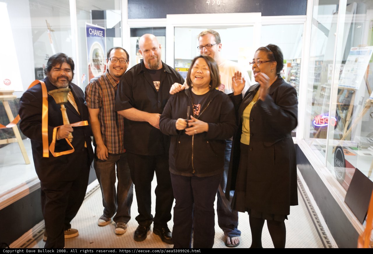 Group of 8 posing in front of a store with accessories