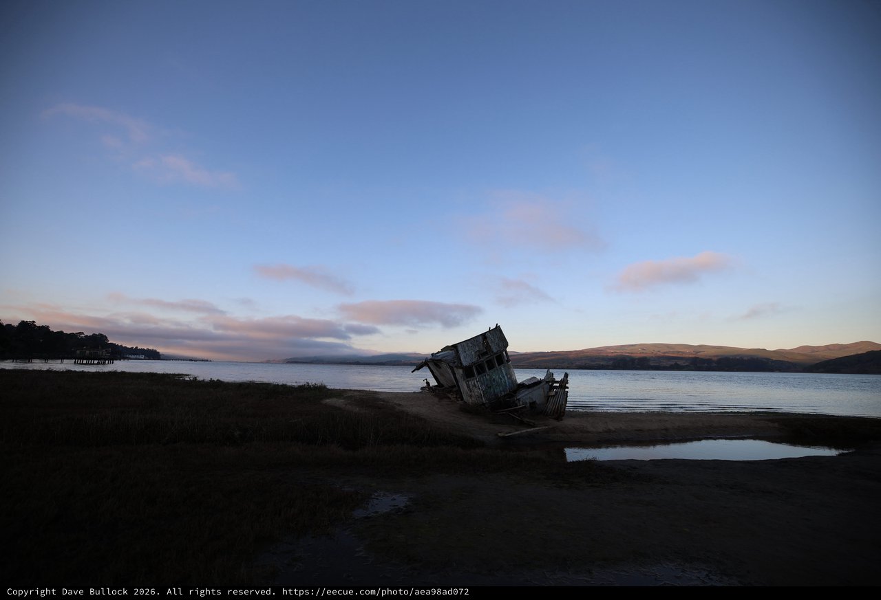 Abandoned Shipwreck at Twilight on Coastal Shore