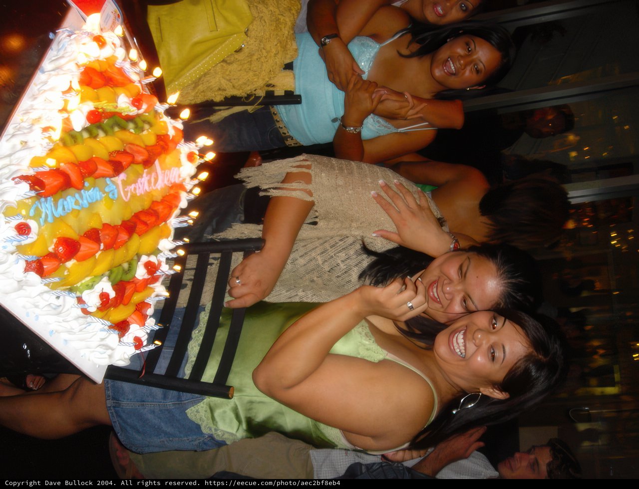 Green Shirted Woman Celebrates with Cake