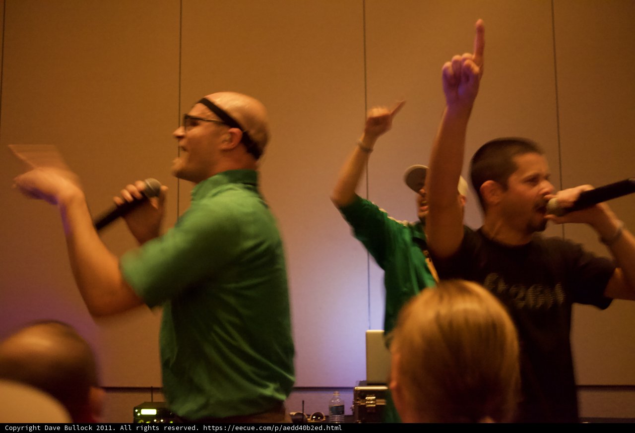 Two men sing along with the crowd