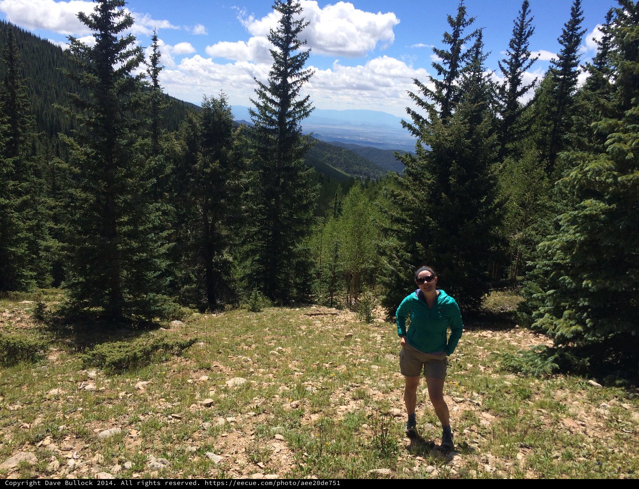 Hiker Poses on Mountain Meadow with Valley Vista
