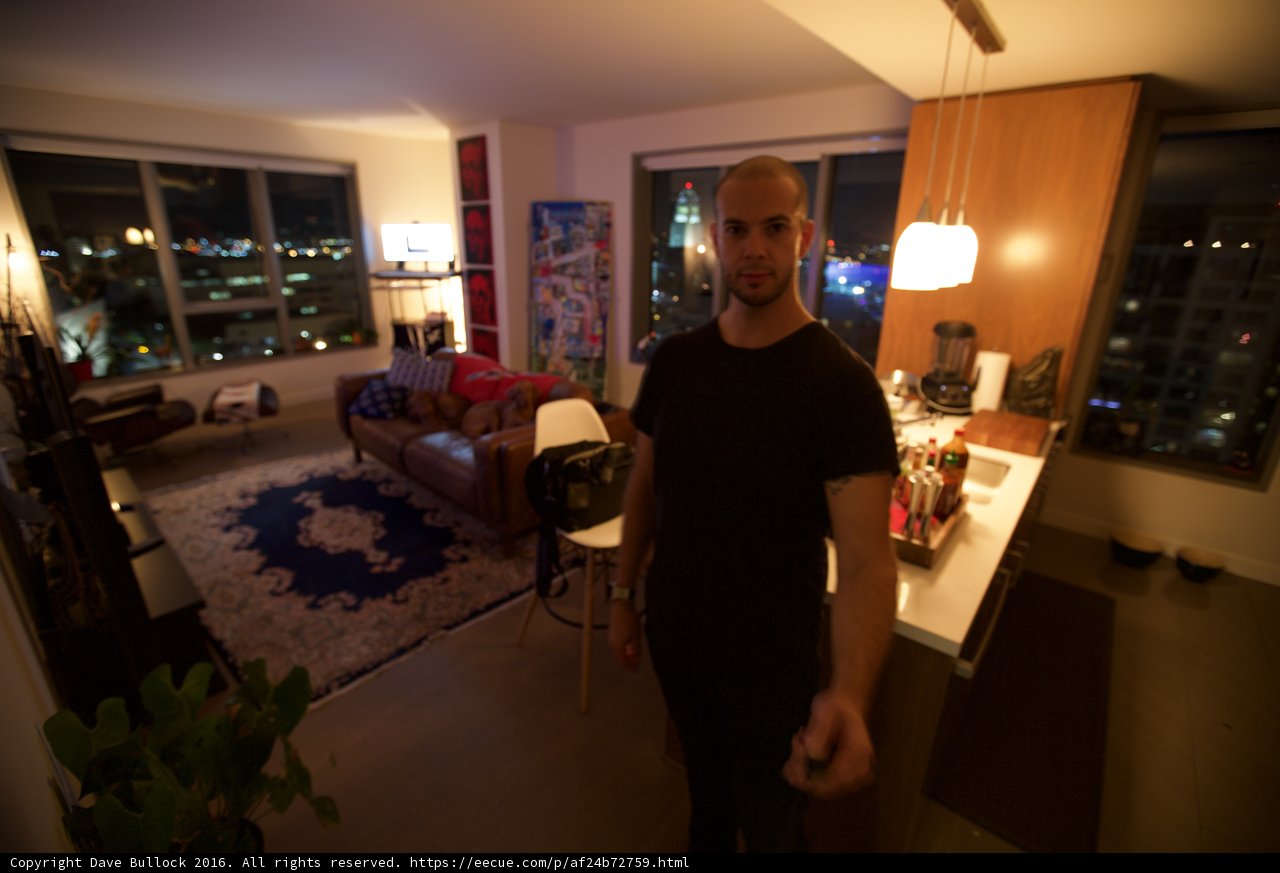 Man Standing in a Stylish Living Room with City View