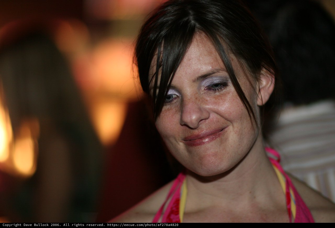 Candid Smiling Woman by Warm Firelight Glow