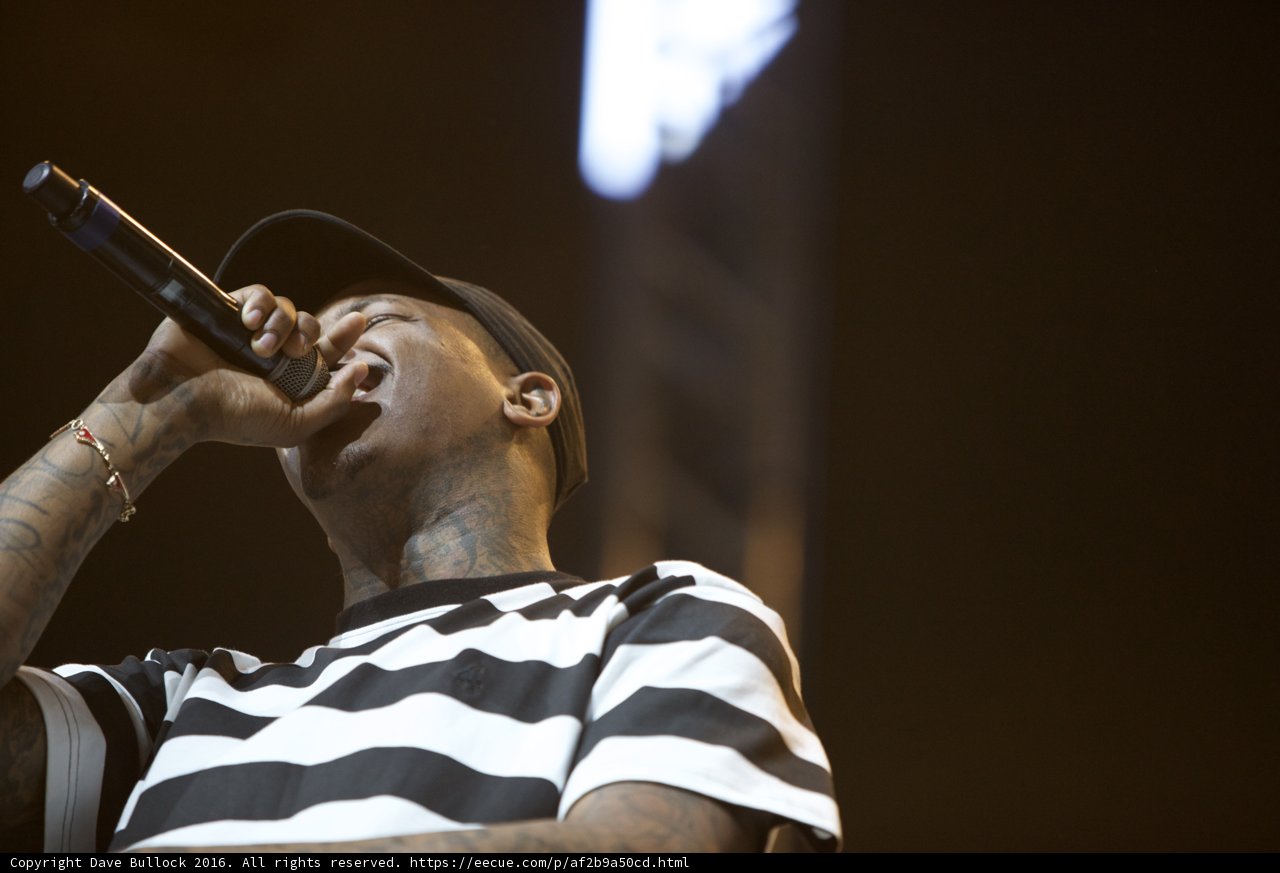 Solo Performance: Tattooed Man Sings Into Microphone