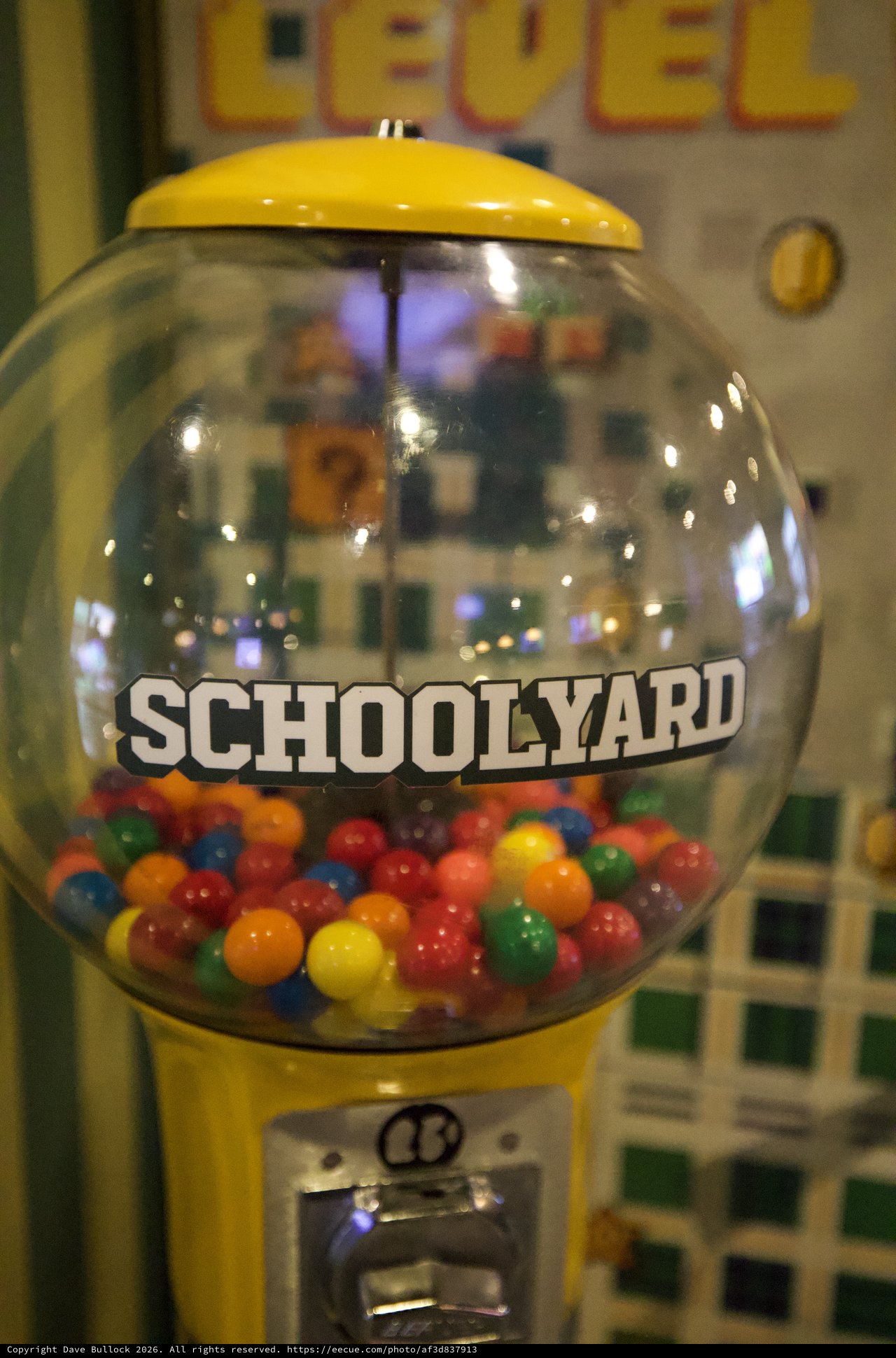 Vintage Yellow Schoolyard Gumball Machine with Colorful Candies