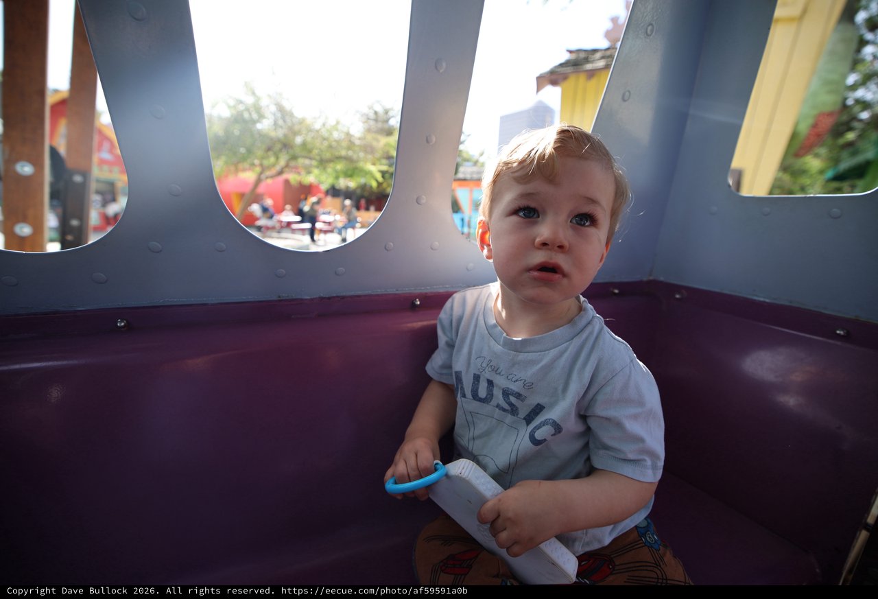 Toddler Playing in Carnival Ride at Fantasyland