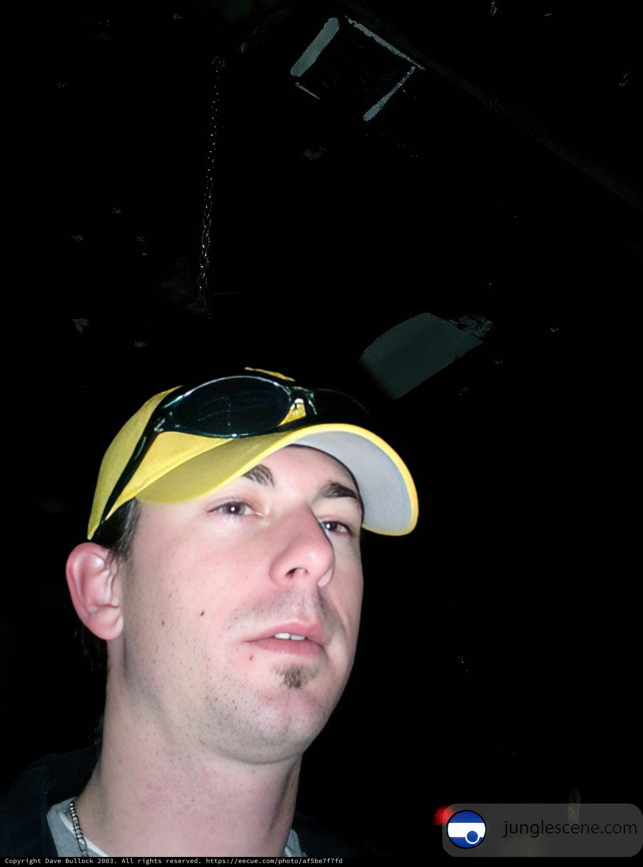 The Man with the Yellow Hat and Shades