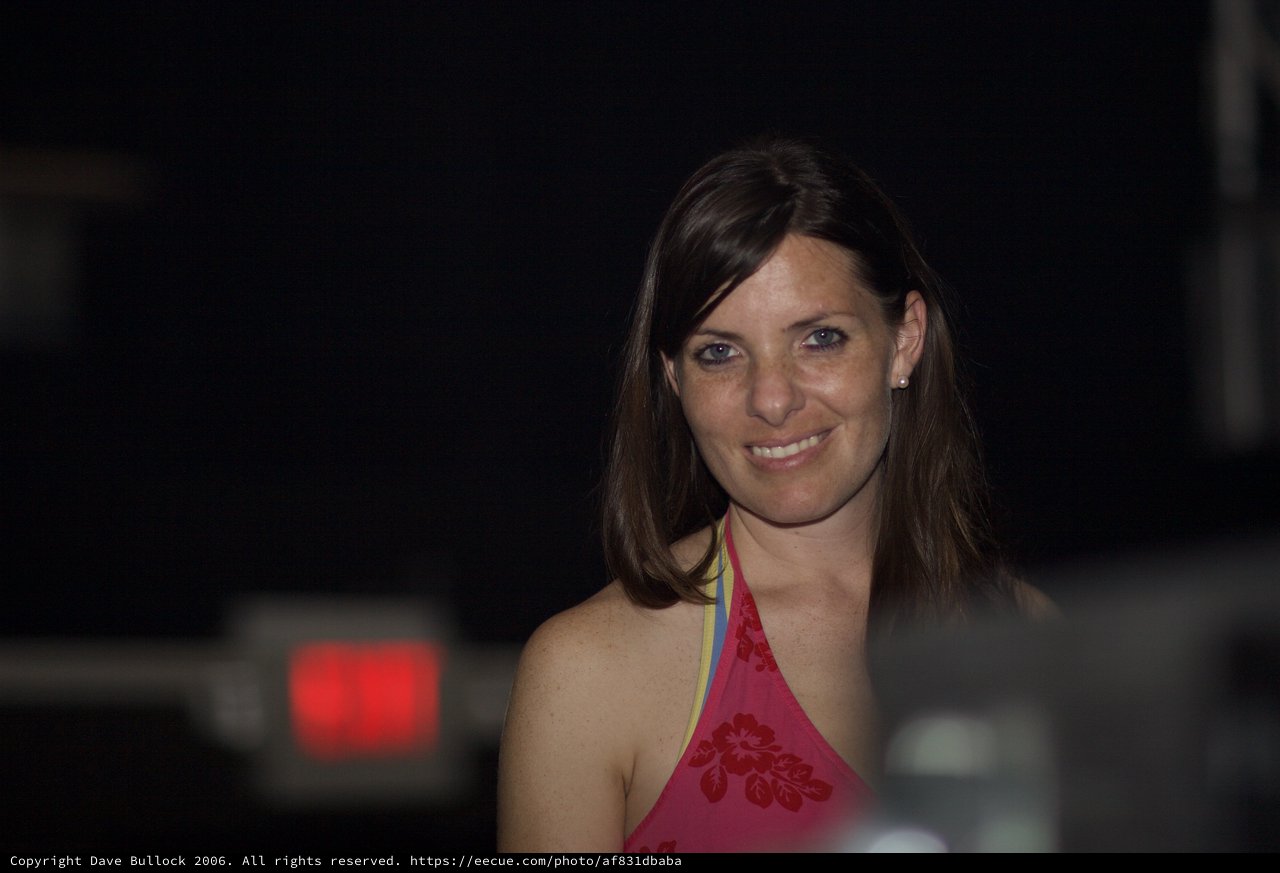 Smiling Woman in Pink Top at Night Event