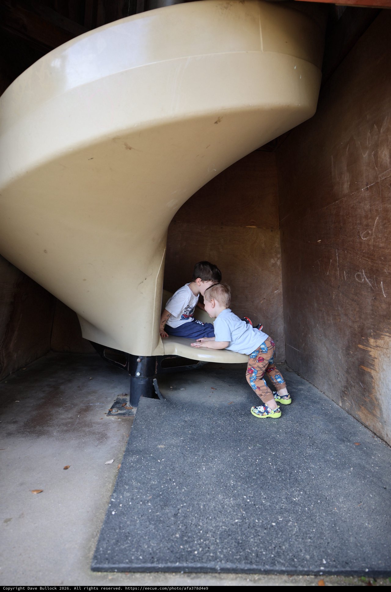 Children Exploring Tunnel Slide at Fantasyland Playground