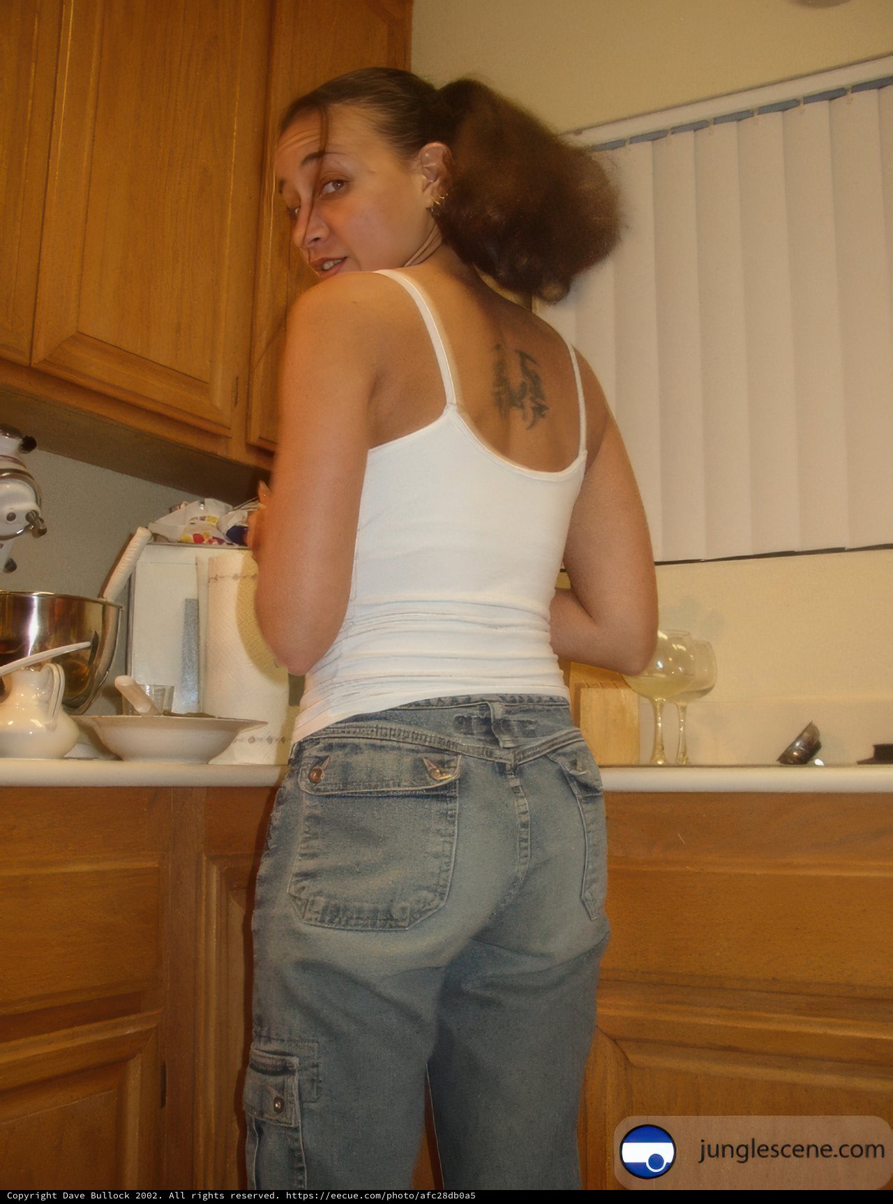 Woman in Jeans Poses in Kitchen