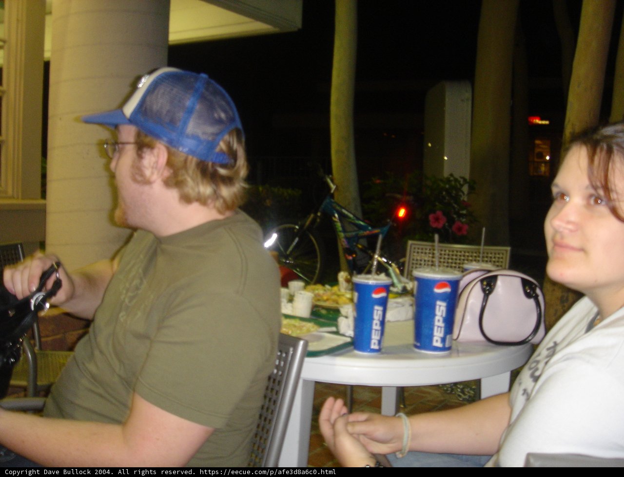 Man in Baseball Hat Sitting at Table