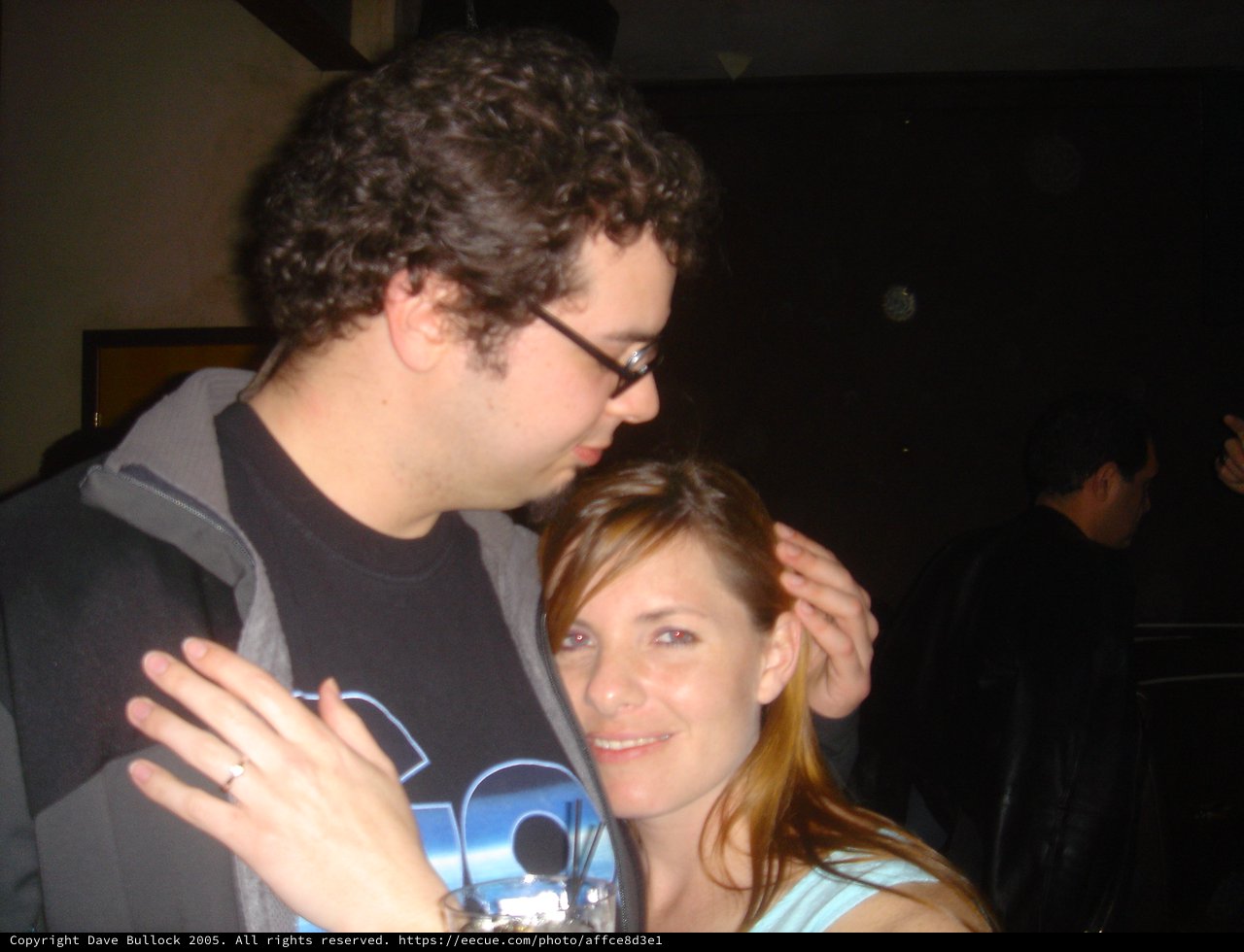Couple Shares Tender Moment at Dimly Lit Bar