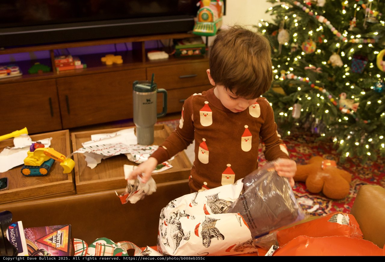 Child Opening Christmas Presents on Christmas Morning