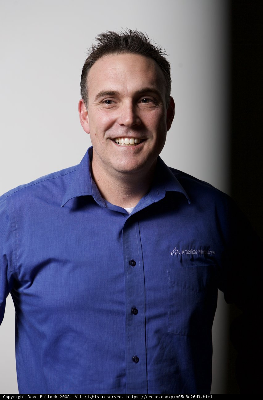 Blue-Shirted Man Beaming for the Camera