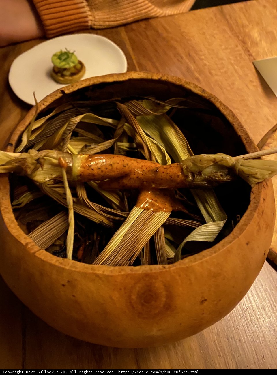 A rustic wooden bowl filled with fresh produce