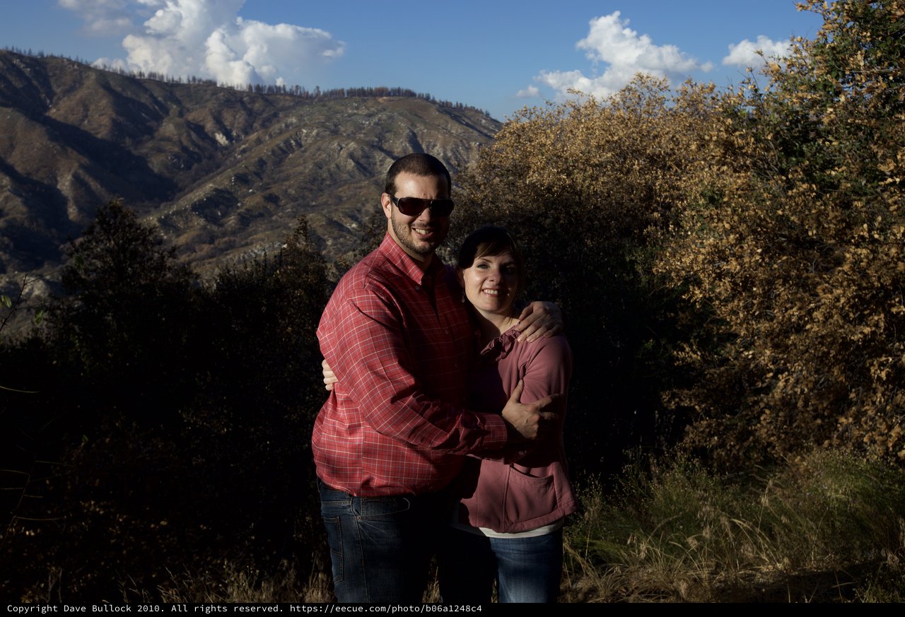 Couple Embracing in Mountain Landscape at Sunset