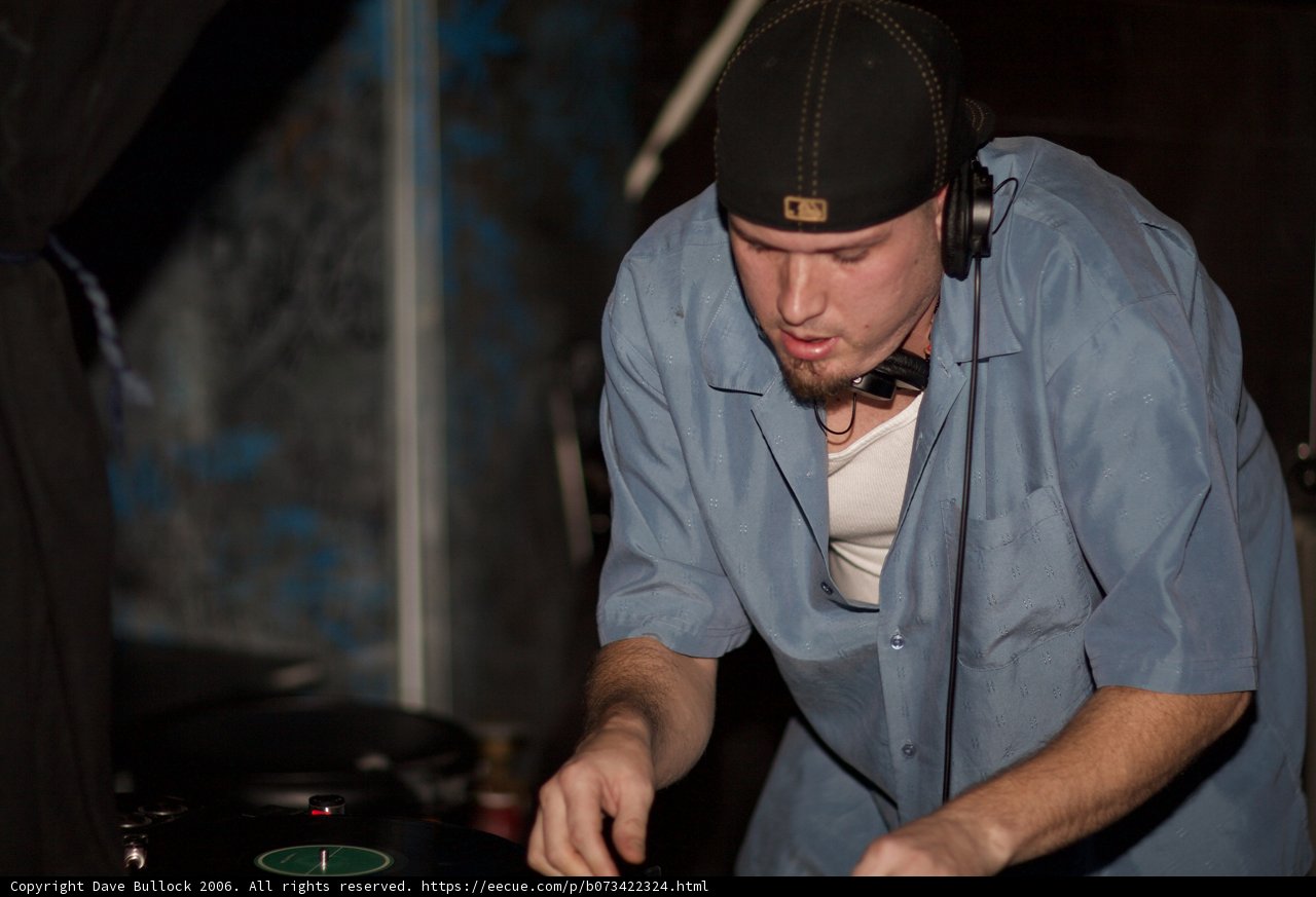 Blue-Shirted Travis B Spins Beats on the DJ Set