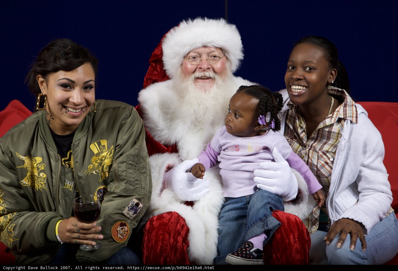 Santa Claus Spreading Christmas Cheer with Women and Child